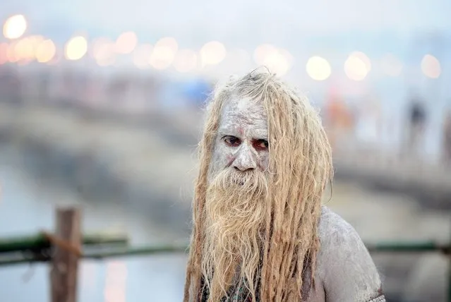 An Indian Sadhu (Hindu holy man) looks on after bathing in the River Ganges and smearing his body with ash, during the Magh Mela festival in Allahabad on January 22, 2017. The Magh Mela is held every year on the banks of Triveni Sangam – the confluence of the three great rivers Ganga, Yamuna and the mystical Saraswati – in Prayag near Allahabad during the Hindu month of Magh which corresponds to mid January-mid February. (Photo by Sanjay Kanojia/AFP Photo)