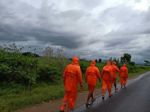 This Photograph provided by India's National Disaster Response Force (NDRF) shows NDRF personnel arriving in preparation for Cyclone Gulab, that likely to make landfall on Sunday evening at Ganjam, eastern Odisha state, India, Sunday, September 26, 2021. (Photo by National Disaster Response Force via AP Photo)