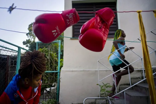 In this January 19, 2017 photo, boxer Legnis Cala runs up a flight of stairs in the backyard of her house, in Havana, Cuba. “I see myself at the Olympics in Japan 2020”, Moreno said. “That's my dream”. Pictured at bottom left is boxer Idamerys Moreno. (Photo by Ramon Espinosa/AP Photo)