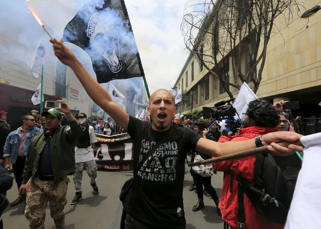 A demonstrator shouts slogans during protests for Labor Day in Bogota, Colombia May 1, 2015. (Photo by Jose Miguel Gomez/Reuters)