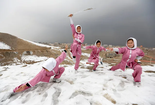 Hanifa Doosti (C), 17,  and other students of the Shaolin Wushu club show their Wushu skills to other students on a hilltop in Kabul, Afghanistan January 29, 2017. (Photo by Mohammad Ismail/Reuters)