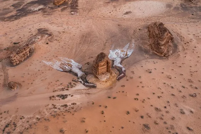 This picture released by the Royal Commission for AlUla on January 27, 2024, shows an aerial view of an ephemeral art installation by US artist David Popa, in the shape of two protective hands, constructed around the Nabatean tomb of Lihyan, son of Kuza, at Hegra in northwestern Saudi Arabia. The installation is part of the first phase of the “I Care” campaign, launched on February 1, 2024, by the Royal Commission for Al-Ula “to celebrate, protect and promote the rich heritage, diversity and history of northwestern Saudi Arabia”. (Photo by David Popa/Royal Commission for Al-ULA via AFP Photo)