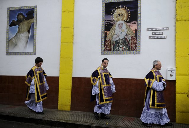 Penitents walk after the governing body of the “Estudiantes” brotherhood decided that penance could not be carried out in the streets due to rain on Palm Sunday in Oviedo, northern Spain, March 20, 2016. (Photo by Eloy Alonso/Reuters)