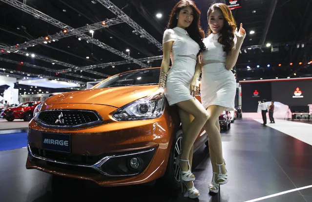Models pose beside a Mitsubishi Mirage during a media presentation at the 37th Bangkok International Motor Show in Bangkok, Thailand, March 22, 2016. (Photo by Chaiwat Subprasom/Reuters)