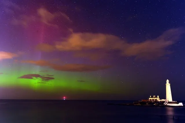 The aurora borealis, or the northern lights as they are commonly known, at St. Mary's Lighthouse and Visitor Centre, Whitley Bay, North Tyneside, on February 27, 2014. (Photo by Owen Humphreys/PA Wire)