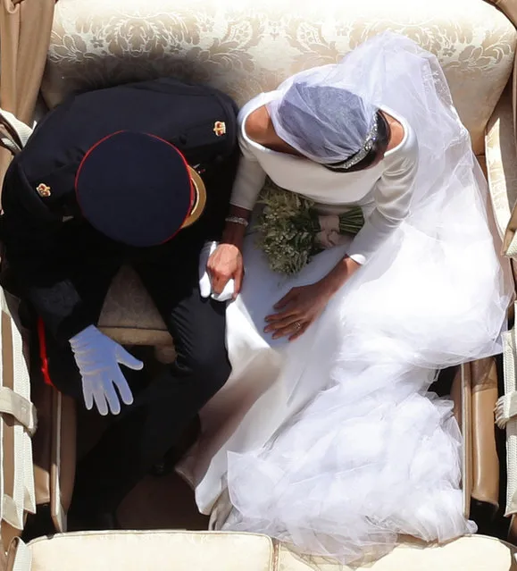 The Duke and Duchess of Sussex ride in a carriage after their wedding in St George’s chapel in Windsor Castle, 19 May 2018. (Photo by Yui Mok/PA Wire)