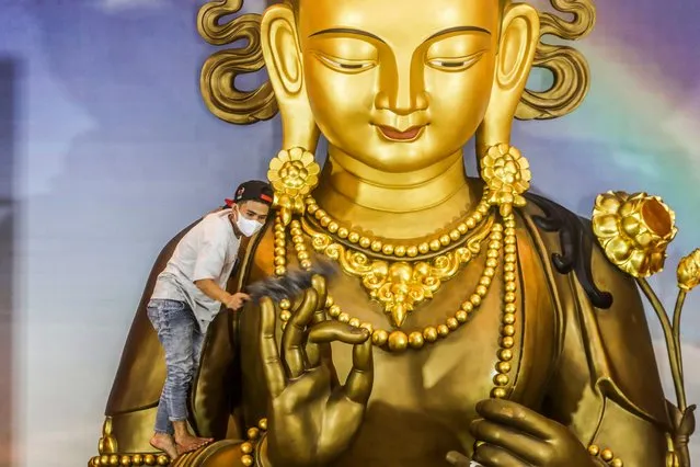 A worker cleans up a Buddha statue as part of preparations for the upcoming Chinese New Year, at Satya Buddha Visudhi Marga temple in Medan, North Sumatra, Indonesia, 12 January 2023. The Chinese Lunar New Year, locally known as “Imlek” falls on 22 January 2023. Indonesian-Chinese are preparing to celebrate the upcoming “Year of the Water Rabbit”. (Photo by Dedi Sinuhaji/EPA/EFE/Rex Features/Shutterstock)