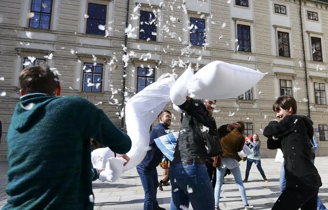 People fight with pillows during World Pillow Fight Day in Vienna, Austria, April 2, 2016. (Photo by Leonhard Foeger/Reuters)