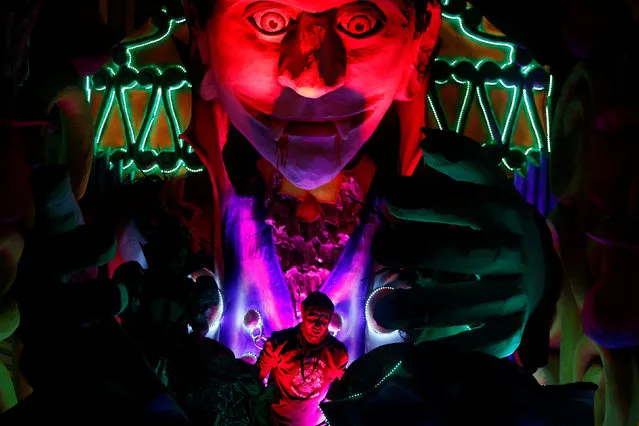 A technician stands on a carnival float depicting a vampire during the carnival street parade in Valletta, Malta, February 25, 2017. (Photo by Darrin Zammit Lupi/Reuters)