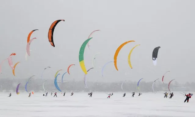 Participants in the 2021 Siberia Snowkiting Cup held on the Berd Bay of the Novosibirsk Reservoir near the city of Novosibirsk, Russia on December 3, 2021. (Photo by Kirill Kukhmar/TASS)
