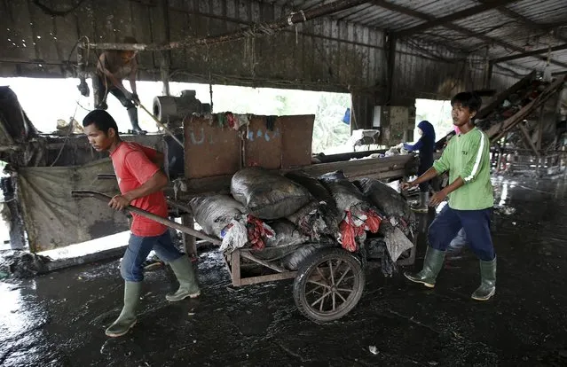 Workers transport sacks of plastic to recycle at a waste treatment facility at Bantar Gebang landfill in Bekasi, West Java province, Indonesia March 2, 2016. (Photo by Darren Whiteside/Reuters)
