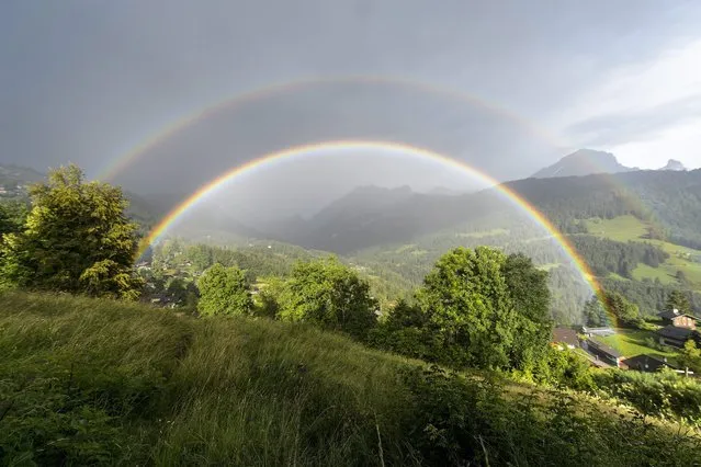 A picture made available on 28 July 2016 shows a double rainbow formed during a storm above Gryon, Switzerland, 27 July 2016. (Photo by Anthony Anex/EPA)