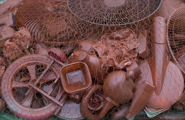Trash collected from the coastline is exhibited as part of a show titled "The Sea Isn't Made for Fish" at the Rio de Janeiro Federal University in Rio de Janeiro, Brazil, Monday, June 1, 2015. Art students at a Rio de Janeiro university have taken advantage of a material they have in endless supply trash to create an exhibition that aims to draw attention to the fetid state of the citys Guanabara Bay, where the Olympic sailing events are to be held next year.  (AP Photo/Silvia Izquierdo)