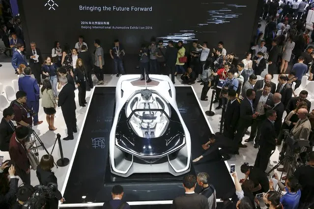 Visitors gather around the Faraday Future FFZERO1 electric concept car during the Auto China 2016 auto show in Beijing April 25, 2016. (Photo by Damir Sagolj/Reuters)