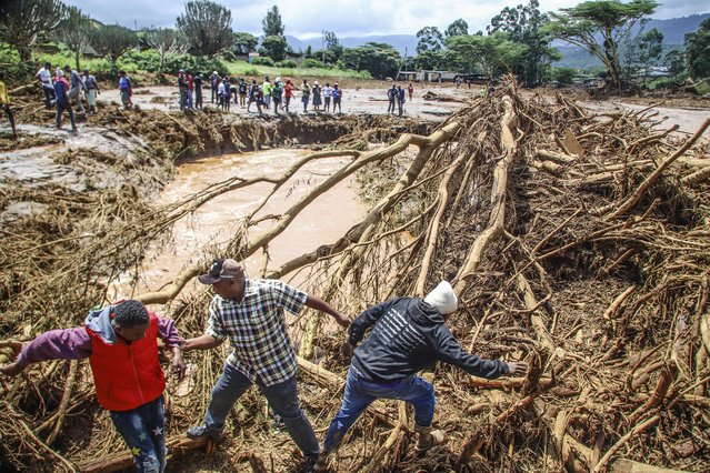 People try to clear the area after a dam burst, in Kamuchiri Village Mai Mahiu, Nakuru County, Kenya, Monday, April 29, 2024. Kenya's Interior Ministry says at least 45 people have died and dozens are missing after a dam collapsed following heavy rains. (Photo by Patrick Ngugi/AP Photo)
