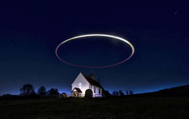 A drone paints a perfect halo over St Hubert's Church, Idsworth in Hampshire, UK on April 23, 2021. Known to locals as “The church in the field” Earl Godwin, head of one of the grandest and most powerful families of Anglo Saxon England, whose most famous son was King Harold, is believed to have had the chapel built sometime around 1030 AD. (Photo by Chris Gorman/Getty Images)