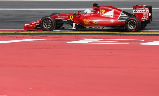 Ferrari driver Sebastian Vettel of Germany steers his car during the the Formula One Grand Prix race, at the Red Bull Ring in Spielberg, southern Austria, Sunday, June 21, 2015. (AP Photo/Darko Bandic)