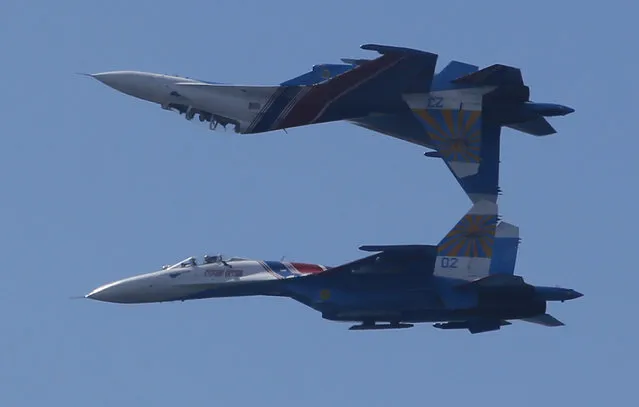 Su-27 jets of aerobatics team Russkiye Vityasy, or Russian Knights perform during the International Maritime Defence show in St.Petersburg, Russia, Thursday, July 2, 2015. (Photo by Dmitry Lovetsky/AP Photo)