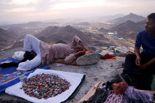 A muslim pilgrim rests at Mount Al-Noor, where Muslims believe Prophet Mohammad received the first words of the Koran through Gabriel in the Hira cave, ahead of the annual haj pilgrimage, in the holy city of Mecca, Saudi Arabia, on June 11, 2024. (Photo by Saleh Salem/Reuters)