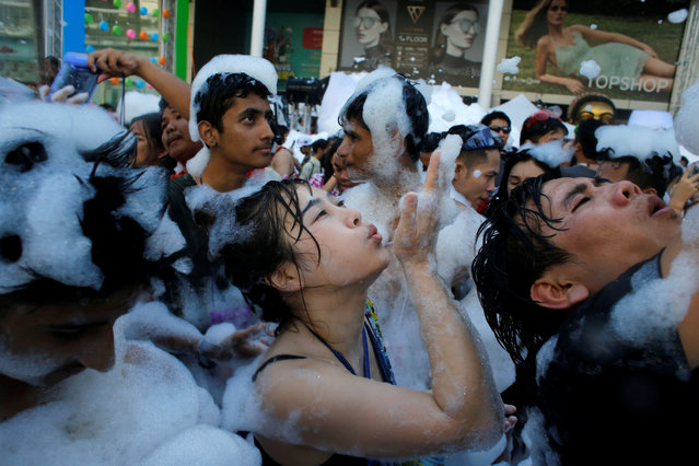 Revellers react at a foam party during Songkran Festival celebrations in Bangkok, Thailand on April 13, 2017. (Photo by Jorge Silva/Reuters)