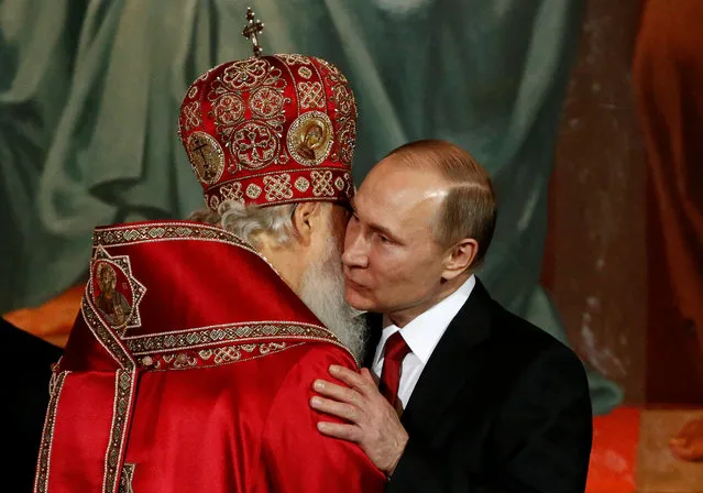 Patriarch Kirill, the head of the Russian Orthodox Church, embraces Russian President Vladimir Putin during the Orthodox Easter service at the Christ the Saviour Cathedral in Moscow, Russia, April 16, 2017. (Photo by Sergei Karpukhin/Reuters)