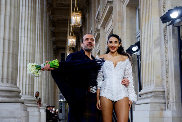 Austrian designer Andreas Kronthaler poses with a model after his Fall-Winter 2023/2024 Women's ready-to-wear collection show for late designer Vivienne Westwood's namesake label during Paris Fashion Week in Paris, France on March 4, 2023. (Photo by Sarah Meyssonnier/Reuters)
