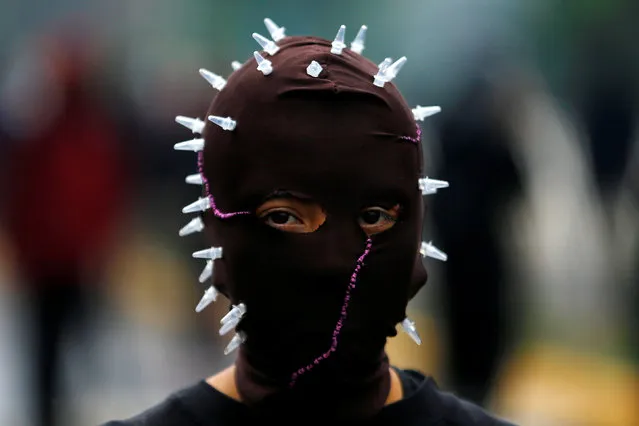 A masked student protester is seen during a demonstration to demand changes in the education system in Santiago, Chile, May 11, 2016. (Photo by Ivan Alvarado/Reuters)