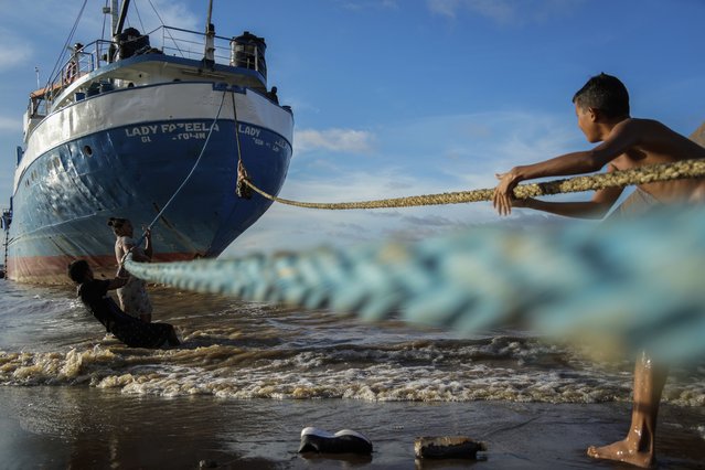 Children play with the ropes of a ship docked on a beach in Parika, Guyana, Sunday, June 9, 2024. (Photo by Ramon Espinosa/AP Photo)