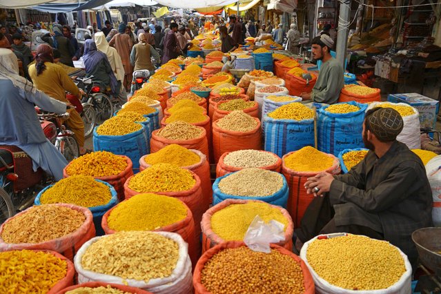 People buy dry fruits ahead of Eid al-Fitr, which marks the end of the Muslim holy fasting month of Ramadan, at a market in Kandahar on April 8, 2024. (Photo by Sanaullah Seiam/AFP Photo)