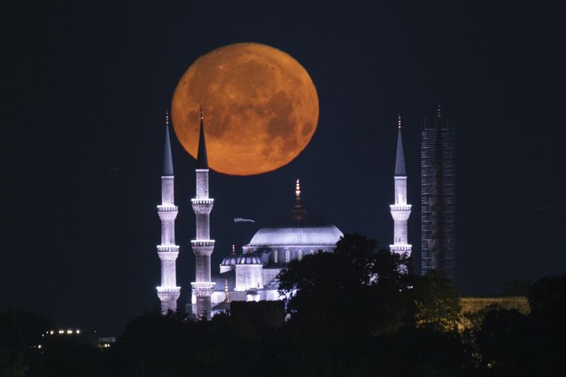 Full Moon rises over Blue Mosque in Istanbul, Turkiye on June 20, 2024. (Photo by Isa Terli/Anadolu via Getty Images)