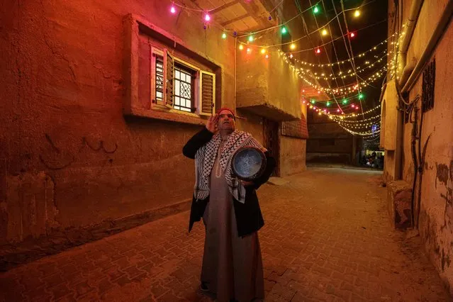 Fifty-year-old Palestinian Nizar al-Dabbas, a “Musaharati” who plays the traditional role of “Ramadan drummer”, awakens Muslims for the pre-dawn traditional “suhur” meal before the start of the following day's fast, during the holy month of Ramadan in Khan Yunis in the southern Gaza Strip early on April 5, 2022. (Photo by Said Khatib/AFP Photo)