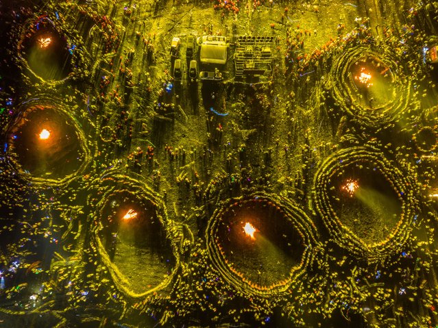 Aerial view of people circling around bonfires to celebrate the Torch Festival on Axilixi Prairie on July 20, 2024 in Bijie, Guizhou Province of China. (Photo by Luo Dafu/VCG via Getty Images)