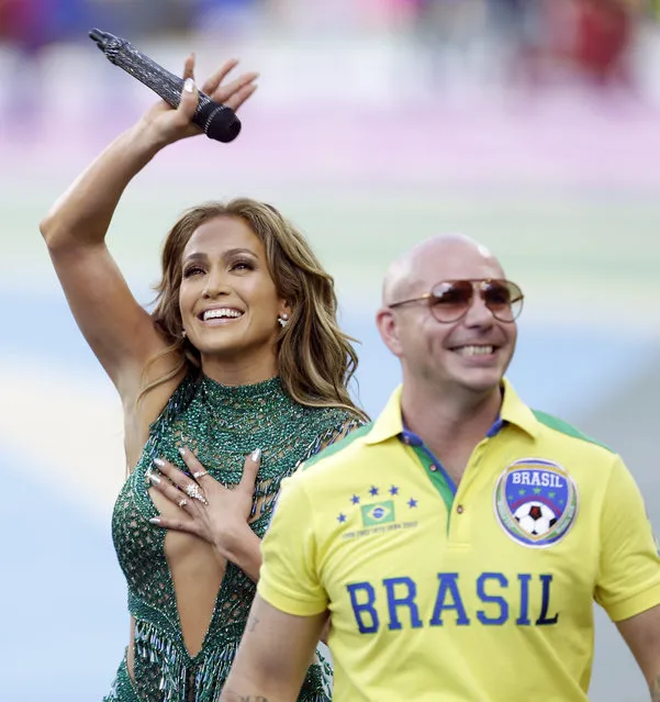 US singer Jennifer Lopez walks off the pitch after performing with rapper Pitbull before the group A World Cup soccer match between Brazil and Croatia, the opening game of the tournament, in the Itaquerao Stadium in Sao Paulo, Brazil, Thursday, June 12, 2014.  (Photo by Andre Penner/AP Photo)