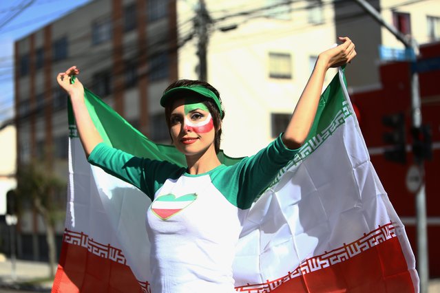 An Iranian fan cheers outside Baixada Arena in Curitiba on June 16, 2014, before the 2014 FIFA World Cup Group F football match between Iran and Nigeria. (Photo by Behrouz Mehri/AFP Photo)