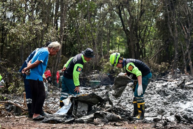 Rescue workers search the wreckage of a small aircraft a day after it crashed as five tourists from China and four Thais, including the two pilots, all presumed dead, in Bang Pakong, Chachoengsao province, Thailand, on August 23, 2024. (Photo by Patipat Janthong/Reuters)