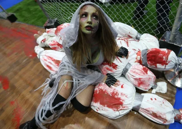A guest dressed as a zombie attends the Middle East Film & Comic Con (MEFCC) in Gulf emirate of Dubai, United Arab Emirates, 11 April 2019. The event runs until 13 April 2019. (Photo by Ali Haider/EPA/EFE)