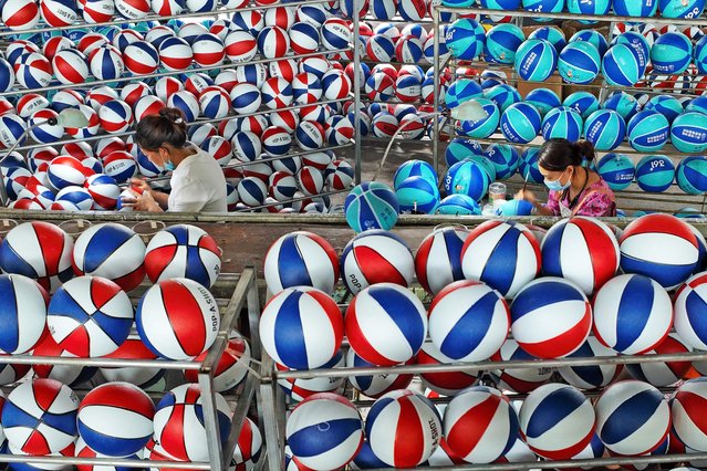 This photo taken on September 12, 2024 shows employees producing basketballs at a factory in Sihong, in eastern China's Jiangsu province. (Photo by AFP Photo/China Stringer Network)