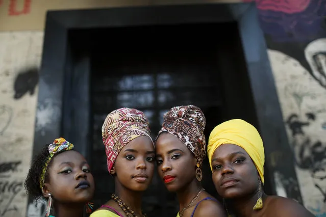 Dancers from the group Lemi Ayo pose at an Afro-Brazilian festival held next to the Valongo slave wharf, entry point in the Americas for nearly one million African slaves, on July 15, 2017 in Rio de Janeiro, Brazil. The Valongo site was designated Unesco heritage status on July 9 and the festival marked the distinction. The wharf was only recently discovered in 2011 during renovations in Rio's port district ahead of the Rio 2016 Olympic Games. Brazil is estimated to have received four million African slaves in total, approximately 40 percent of the total enslaved people shipped to the Americas. (Photo by Mario Tama/Getty Images)