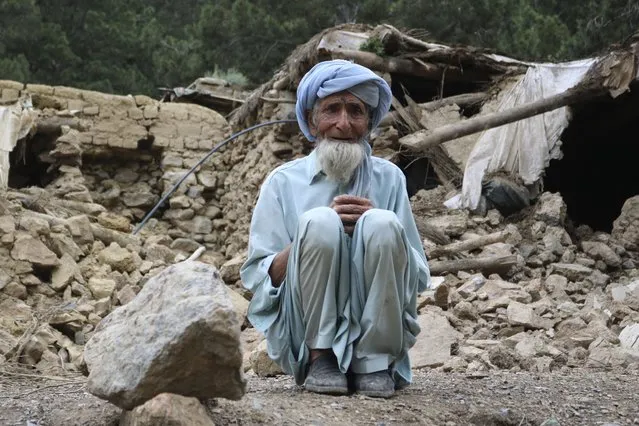 An Afghan man sits near his house that was destroyed in an earthquake in the Spera District of the southwestern part of Khost Province, Afghanistan, Wednesday, June 22, 2022. A powerful earthquake struck a rugged, mountainous region of eastern Afghanistan early Wednesday, killing at least 1,000 people and injuring 1,500 more in one of the country's deadliest quakes in decades, the state-run news agency reported. (Photo by AP Photo/Stringer)