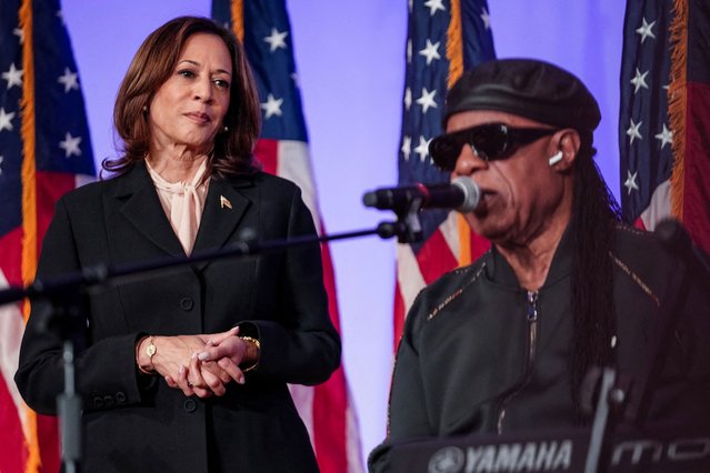 Kamala Harris looks on as Stevie Wonder sings 'Happy Birthday' to her during a Souls to the Polls Sunday service at Divine Faith Ministries International Church in Jonesboro, Georgia on October 20, 2024. (Photo by Elijah Nouvelage/Reuters)