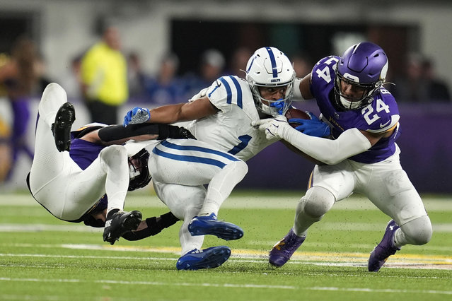 Indianapolis Colts wide receiver Josh Downs (1) is tackled by Minnesota Vikings cornerback Byron Murphy Jr., left, and safety Camryn Bynum (24) during the second half of an NFL football game, Sunday, November 3, 2024, in Minneapolis. (Photo by Abbie Parr/AP Photo)