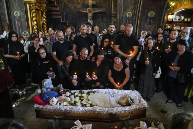 Relatives and friends pay their last respects to Liza, a 4-year-old girl killed by a Russian attack, during a mourning ceremony in an Orthodox church in Vinnytsia, Ukraine, Sunday, July 17, 2022. (Photo by Efrem Lukatsky/AP Photo)