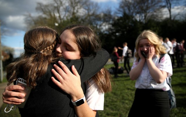 Georgia Mayer, aged 16, says goodbye to her friends at a school in Newcastle-under-Lyme as the majority of schools in the UK close in Newcastle-under-Lyme, London, Britain on March 20, 2020. (Photo by Carl Recine/Reuters)