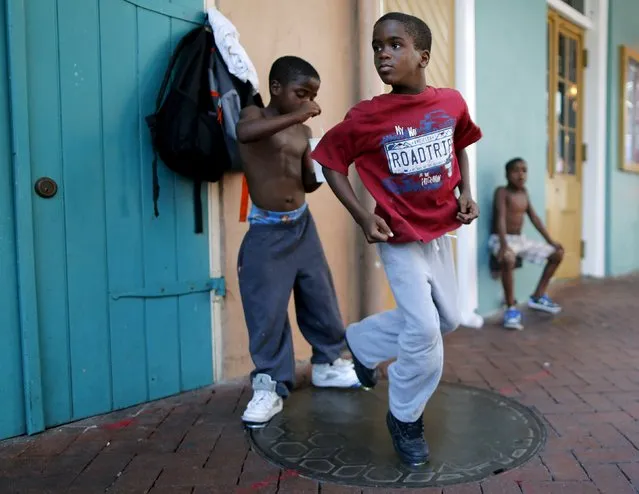 A boy tap dances on a sidewalk in the French Quarter one day before the ten year anniversary of Hurricane Katrina in New Orleans, Louisiana, August 28, 2015. REUTERS/Jonathan Bachman