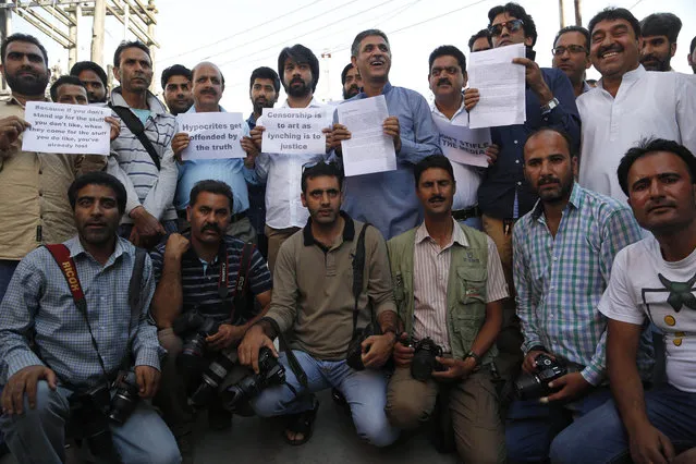 Local journalists hold placards during a protest in Srinagar, India, Tuesday, July 19, 2016. Authorities in the Indian-controlled portion of Kashmir lifted a three-day ban on the publication of newspapers imposed during massive anti-India protests that left dozens of people dead and hundreds injured, and editors said they will decide together whether to resume publication later Tuesday. (Photo by Mukhtar Khan/AP Photo)