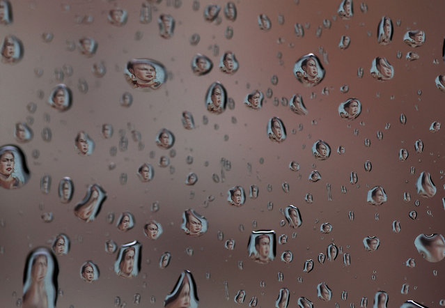A mural of Mexican artist Frida Kahlo is seen reflected in raindrops on a car window on November 22, 2024 in Fulton, California. A powerful atmospheric river is bringing heavy rains and wind to the San Francisco Bay Area for the third straight day and is expected to rain through the weekend. (Photo by Justin Sullivan/Getty Images)