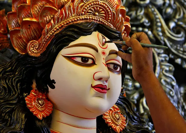 An artisan applies finishing touches on an idol of the Hindu goddess Durga, before it is transported to a pandal, or a temporary platform, ahead of the Durga Puja festival in Kolkata, India September 21, 2017. (Photo by Rupak De Chowdhuri/Reuters)
