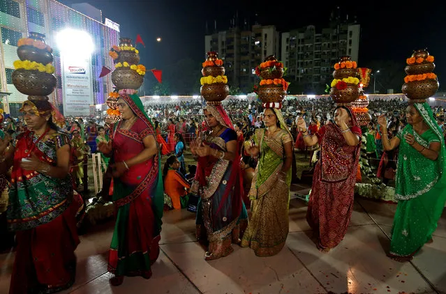 Hindu devotees perform Garba, a traditional folk dance, during the celebrations to mark the Navratri festival, in which devotees worship Hindu goddess Durga, at Surat in the western state of Gujarat, India, September 28, 2017. (Photo by Amit Dave/Reuters)