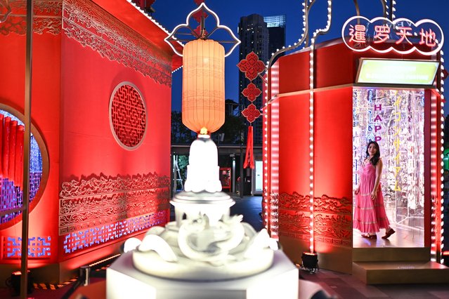 A woman poses for photographs with Lunar New Year decorations at a shopping mall in Bangkok on January 26, 2025 ahead of the Year of the Snake which falls on January 29. (Photo by Manan Vatsyayana/AFP Photo)