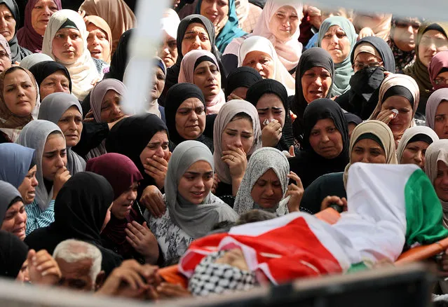 Palestinian mourners attend the funeral of Uday Salah, 17, in the village of Kafr Kod, east of Jenin in the occupied West Bank, on September 15, 2022. The Palestinian teenager was killed during clashes with the Israeli army near Jenin, medical sources said. (Photo by Jaafar Ashtiyeh/AFP Photo)